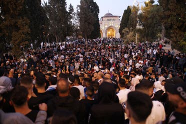 Muslim worshippers gather at the al-Aqsa mosques compound in Old Jerusalem for the morning Eid al-Fitr prayer early on May 13, 2021. (AFP)