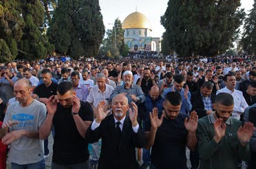 Muslims perform the morning Eid al-Fitr prayer, marking the end of the holy fasting month of Ramadan, outside the Dome of the Rock mosque in the al-Aqsa mosques compound in Old Jerusalem early on May 13, 2021. (AFP)
