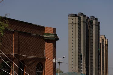 Apartment towers rise behind the former Xinqu Mosque that had its minarets removed in Changji outside Urumqi, Xinjiang Uyghur Autonomous Region, China, May 6, 2021. (Reuters)