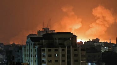 An explosion lights the sky following an Israeli air strike on Beit Lahia in the northern Gaza Strip on May 14, 2021. (AFP)