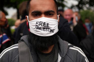A protester wears a face mask reading Free Palestine during a protest in solidarity with Palestinians, in Paris, Wednesday, May 12, 2021. (AP)