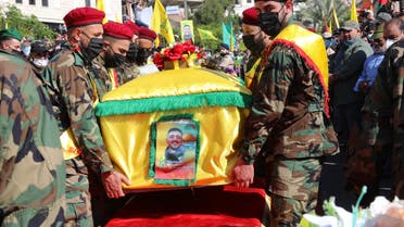 Members of the Iran-backed Hezbollah movement, carry the coffin of Mohamad Kassem Tahan, a fellow member killed a day earlier by Israeli shelling on the frontier with Lebanon during a protest against the latest assault on the Gaza Strip, at his funeral in the southern Lebanese village of Adloun, on May 15, 2021. (AFP)