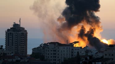 Smoke and flame rise during Israeli air strikes in Gaza City on May 14, 2021. (Reuters)