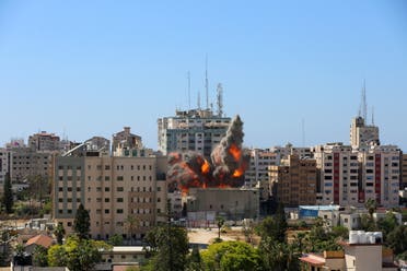 A tower housing AP, Al Jazeera offices collapses after Israeli missile strikes in Gaza city on May 15, 2021. (Reuters)