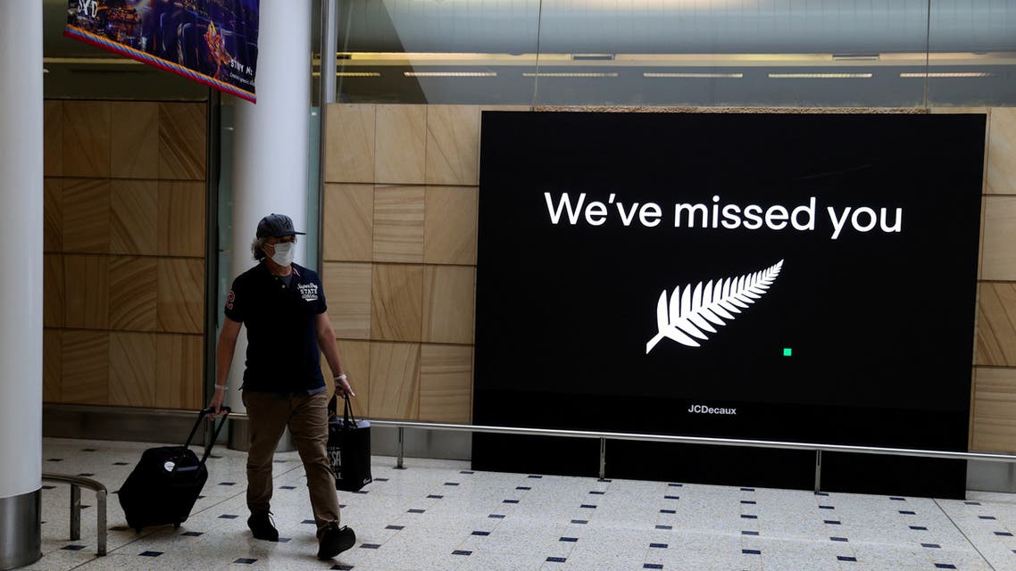 FILE PHOTO: A passenger arrives from New Zealand after the Trans-Tasman travel bubble opened overnight, following an extended border closure due to the coronavirus disease (COVID-19) outbreak, at Sydney Airport in Sydney, Australia, October 16, 2020. REUTERS/Loren Elliott/File Photo
