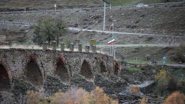 A view shows the ancient Khodaafarin Bridge near the border with Iran in the area, which came under the control of Azerbaijan's troops following a military conflict over Nagorno-Karabakh against ethnic Armenian forces and a further signing of a ceasefire deal, with Iranian service members seen in the background, in Jabrayil District, December 7, 2020. Picture taken December 7, 2020. REUTERS/Aziz Karimov