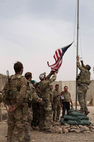 US soldiers lowering the US national flag during a handover ceremony to the Afghan National Army (ANA) army 215 Maiwand corps at Antonik camp in Helmand province. (File photo)