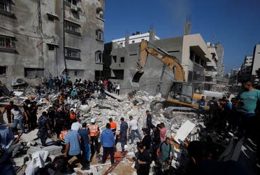 Rescue workers search for victims amid rubble at the site of Israeli air strikes, in Gaza City May 16, 2021. (Reuters)