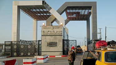 A Palestinian security officer checks passengers at Rafah border crossing after it was opened by Egyptian authorities, in the southern Gaza Strip February February 11, 2021. REUTERS/Suhaib Salem