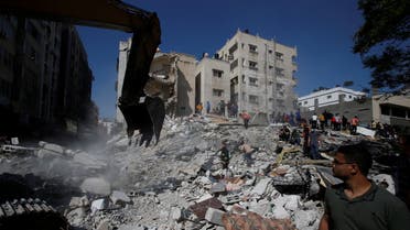 Rescue workers search for victims amid rubble at the site of Israeli air strikes, in Gaza City May 16, 2021. (Reuters)