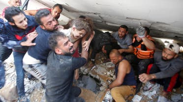 Rescuers carry a girlTitle: SENSITIVE MATERIAL. THIS IMAGE MAY OFFEND OR DISTURB People recover the body of a dead Palestinian girl from the rubble of a house that local medics said was hit by Israeli air strikes in Gaza City May 16, 2021. REUTERS/Mohammed Salem Image Caption إنقاذ طفلة من تحت ركام عمارة محطمة في غزة بسبب القصف الإسرائيلي as they search for victims amid rubble at the site of Israeli air strikes, in Gaza City May 16, 2021. REUTERS/Mohammed Salem TPX IMAGES OF THE DAY