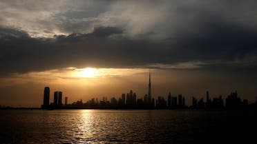Sun sets behind the city skyline and the world tallest tower, Burj Khalifa in Dubai, United Arab Emirates, Friday, Feb. 19, 2021. (AP)