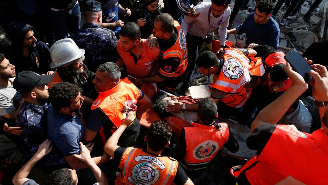 Rescue workers carry a victim on a stretcher amid rubble at the site of Israeli air strikes, in Gaza City. (Reuters)