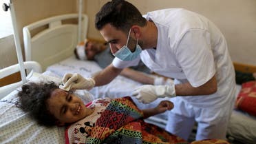 Palestinian girl Suzy Eshkuntana, 6, is treated by a medic at a hospital after being pulled from the rubble of a building amidst Israeli air strikes, in Gaza City May 16, 2021. REUTERS/Mohammed Salem SEARCH SUZY ESHKUNTANA FOR THIS STORY. SEARCH WIDER IMAGE FOR ALL STORIES.