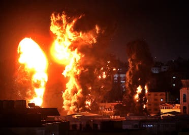 Fire and smoke rise above buildings in Gaza City as Israeli warplanes target the Palestinian enclave, early on May 17, 2021. (AFP)