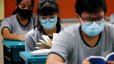 FILE PHOTO: Students wearing protective face masks read in class at Yio Chu Kang Secondary School, as schools reopen amid the coronavirus disease (COVID-19) outbreak in Singapore June 2, 2020. (File Photo: Reuters)
