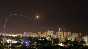 A streak of light is seen as Israel's Iron Dome anti-missile system intercepts rockets launched from the Gaza Strip towards Israel, as seen from Ashkelon, Israel. (Reuters)