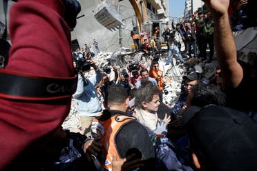 Rescuers carry Suzy Eshkuntana, 6, as they pull her from the rubble of a building at the site of Israeli air strikes, in Gaza City May 16, 2021. (Reuters)