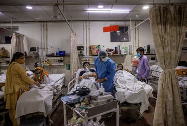 Rohan Aggarwal, 26, a resident doctor treating patients suffering from the coronavirus disease (COVID-19), tends to a patient during his 27-hour shift at Holy Family Hospital in New Delhi, India, May 1, 2021.