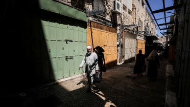 A Palestinian man walks past closed shops during a general strike called by Palestinians in the Israeli-occupied West Bank and Arab cities in Israel, over Israel-Gaza fighting, at a market in Jerusalem's Old City May 18, 2021. (Reuters)