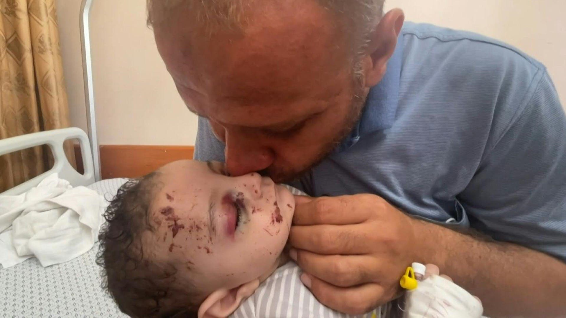 Inside a Gaza hospital, Mohammad al-Hadidi cradled his baby boy Omar -- his only surviving child after Israeli air strikes killed his wife and four other sons in the night. (File photo: AFP)