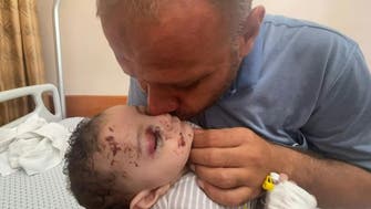 Gaza father who lost entire family in Israeli air strike holds his only surviving son