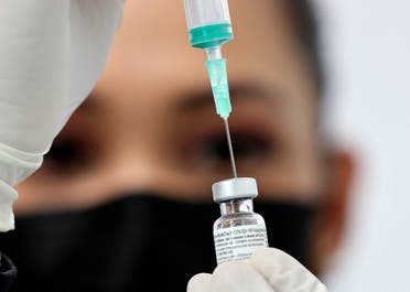 A health worker prepares an injection of the Pfizer-BioNTech vaccine against the coronavirus at a vaccination centre, set up at the Dubai International Financial Center in the Gulf emirate of Dubai, on February 3, 2021. (AP)