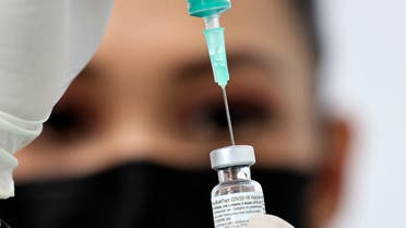 A health worker prepares an injection of the Pfizer-BioNTech vaccine against the coronavirus at a vaccination centre, set up at the Dubai International Financial Center in the Gulf emirate of Dubai, on February 3, 2021. (AP)
