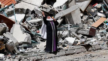 A woman reacts while standing near the rubble of a building that was destroyed by an Israeli airstrike on Saturday that housed The Associated Press, broadcaster Al-Jazeera and other media outlets, in Gaza City. (AP)