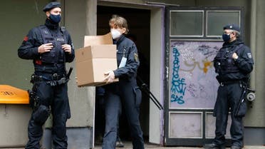 A policewoman carries box with evidence out of a building in Berlin’s Kreuzberg district during raids of properties on November 17, 2020 in connection with a spectacular heist on Green Vault museum in Dresden’s Royal Palace on November 25, 2019. (AFP)