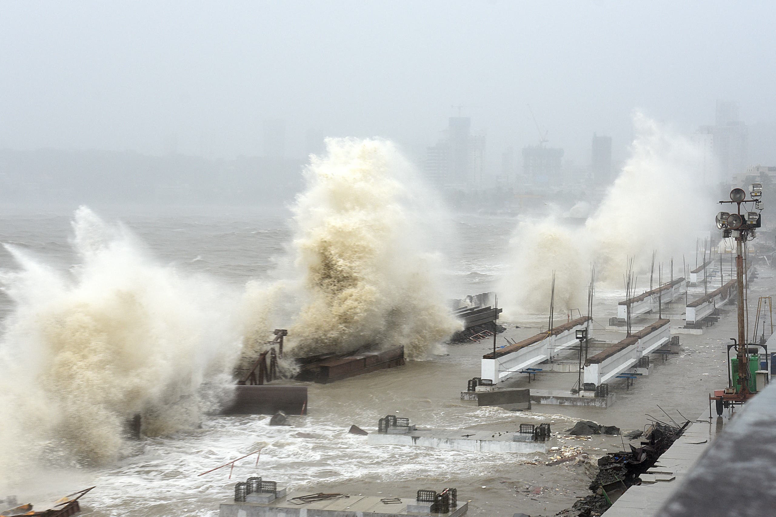 Waves lash over onto a shoreline in Mumbai on May 17, 2021, as Cyclone Tauktae, packing ferocious winds and threatening a destructive storm, surge bore down on India, disrupting the country's response to its devastating Covid-19 outbreak.