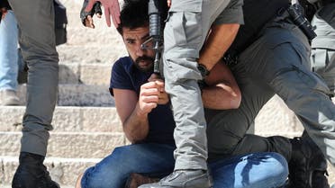 Israeli security forces detain a protester during a demonstration held by Palestinians to show their solidarity amid Israel-Gaza fighting, in Jerusalem's Old City, May 18, 2021. (Reuters)
