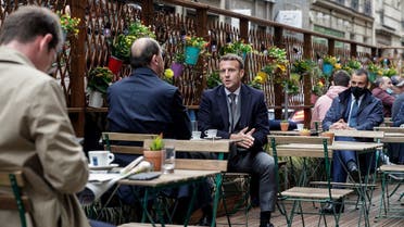 French President Emmanuel Macron (R) and French Prime Minister Jean Castex (L) are having coffees at a cafe terrace in Paris on May 19, 2021, as restaurant and bar terraces reopen today at 50-percent capacity for groups of up to six while the curfew will be pushed back from 7 to 9:00 pm. (AFP)