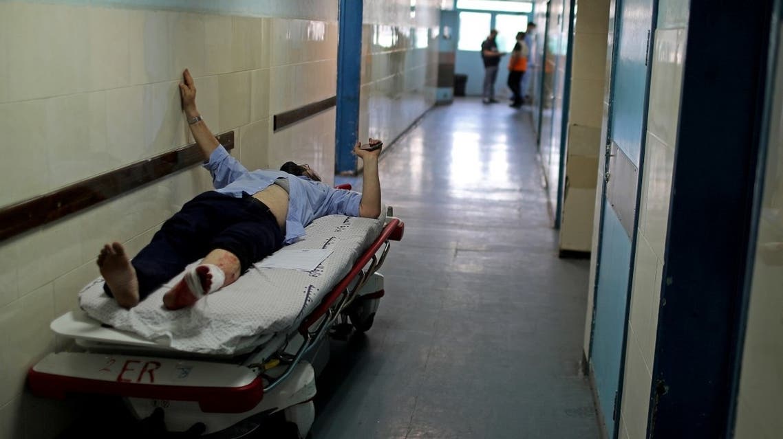 A wounded Palestinian man lies on a bed in Shifa hospital in Gaza City. (Reuters)