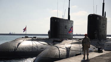 A Russian soldier stands next to submarines at the Russian naval base in the Syrian Mediterranean port of Tartus on September 26, 2019. With military backing from Russia, President Bashar al-Assad's forces have retaken large parts of Syria from rebels and jihadists since 2015, and now control around 60 percent of the country. Russia often refers to troops it deployed in Syria as military advisers even though its forces and warplanes are also directly involved in battles against jihadists and other rebels
