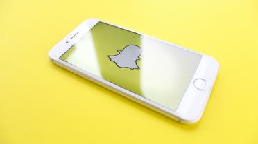 Snapchat logo displayed on an iPhone screen. (@ThoughCatalog, Unspalsh)