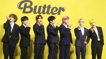 Members of South Korean K-pop boy band BTS pose for photographs during a press conference to promote their new single album 'Butter' in Seoul on May 21, 2021. (AFP)