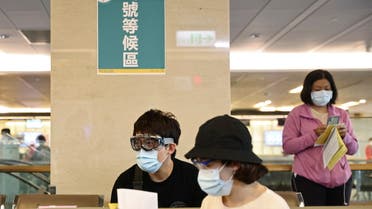 People wearing protective gear sit at a waiting area during a vaccination session for healthcare workers following the recent rise in coronavirus disease (COVID-19) infections, at Far Eastern Memorial Hospital in New Taipei City, Taiwan May 20, 2021. REUTERS/Ann Wang