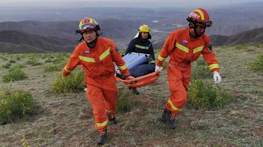Rescue workers carry a stretcher as they work at the site where extreme cold weather killed participants of an 100-km ultramarathon race in Baiyin, Gansu province, China May 22, 2021. (Reuters)