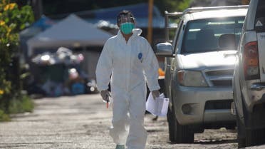 A healthcare worker walks near a workers' dormitory where more than a thousand COVID-19 cases were detected, in Bangkok, Thailand May 22, 2021. (Reuters)