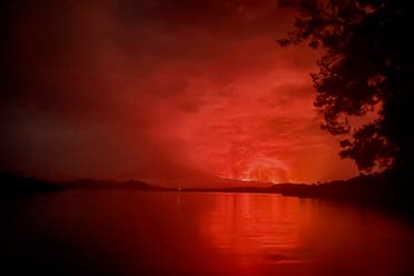 This general view taken on May 22, 2021 from Tchegera Island outsoide Goma on the lake Kivu in the East of the Democratic Republic of Congo shows flame spewing from the Nyiragongo volcano. (AFP)