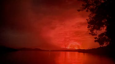 This general view taken on May 22, 2021 from Tchegera Island outsoide Goma on the lake Kivu in the East of the Democratic Republic of Congo shows flame spewing from the Nyiragongo volcano. The famous Nyiragongo volcano, near the city of Goma, in the east of the Democratic Republic of the Congo (DRC), suddenly became active on Saturday evening, an AFP correspondent noted. Strong emanations of glowing light coming out of the crater were visible from Goma, while a smell of sulfur was perceptible in the city, located on the southern flank of the volcano, on the shores of Lake Kivu, he noted. (AFP)