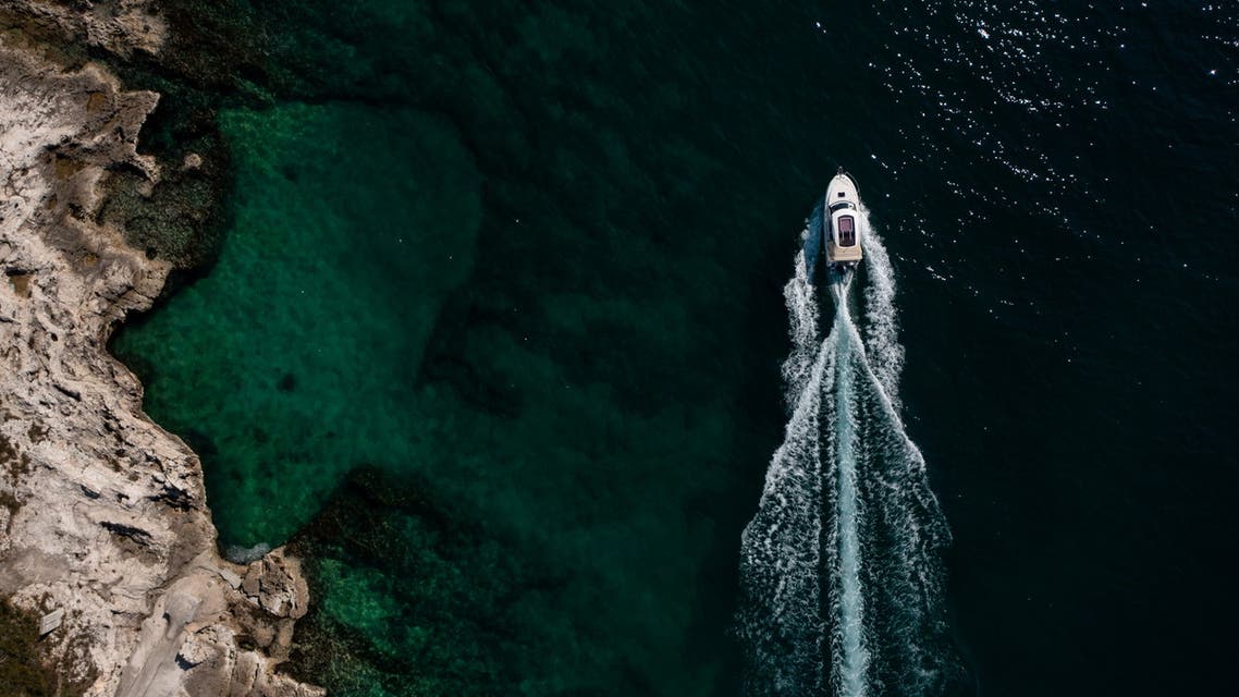 Boat passes in the Adriatic sea off Porec coast, Croatia, April 20, 2021. Picture taken with drone on April 20, 2021. (Reuters)