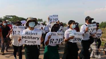 Demonstrators carry placards as university students, engineers and teachers along with others march during a protest against the military coup in Dawei, Myanmar April 4, 2021. (Reuters)