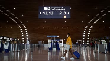 A woman makes her way in the departures area of the Terminal 2E at Charles-de-Gaulle airport amid the coronavirus disease (COVID-19) outbreak, in Roissy, near Paris, France April 2, 2021. (Reuters)