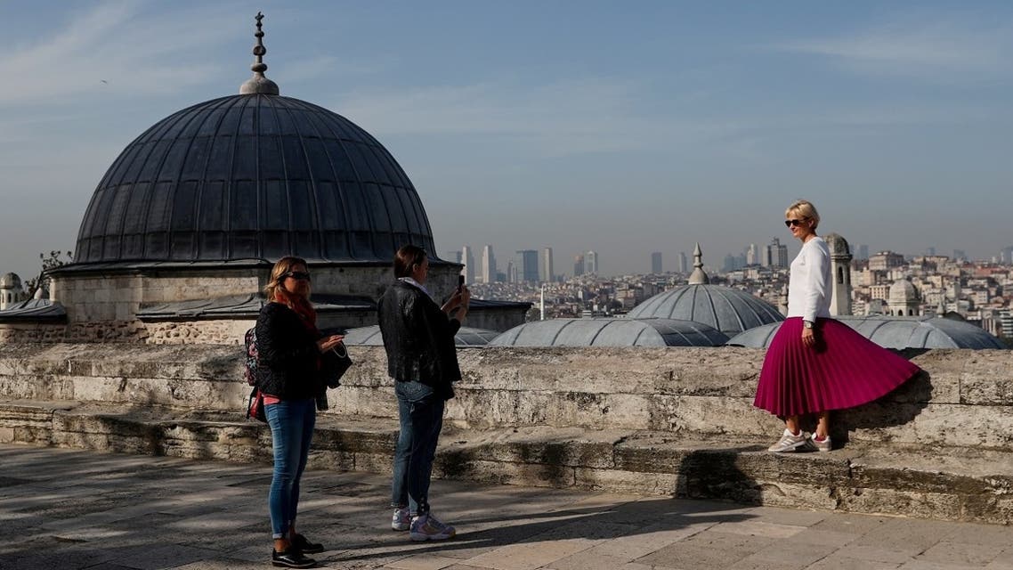 A tourist poses for a souvenir photo outside the historic Suleymaniye Mosque in Istanbul, Turkey, during a nationwide lockdown of the local population imposed to slow the spread of the coronavirus, on April 30, 2021. (Reuters)