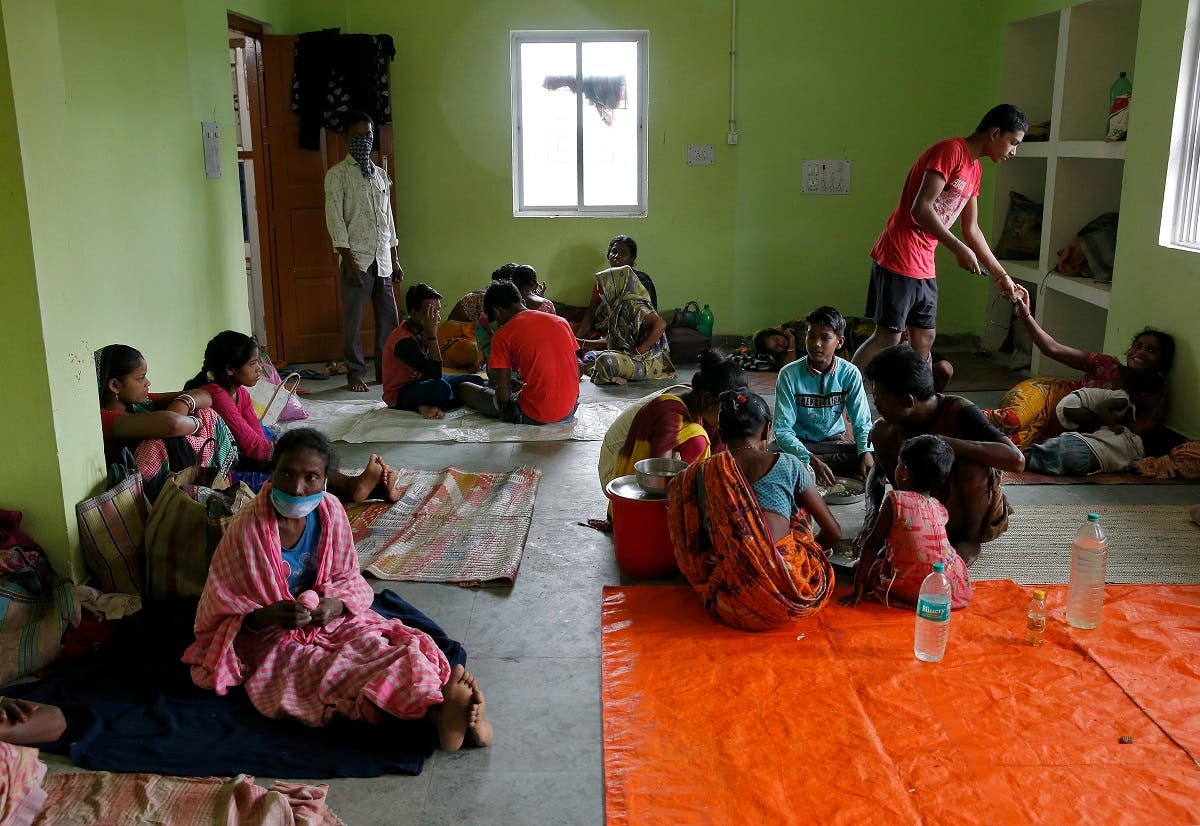 People rest inside a shelter after they were evacuated from their houses in coastal areas ahead of Cyclone Yaas at Digha in Purba Medinipur district in the eastern state of West Bengal, India, on May 25, 2021. (Reuters)