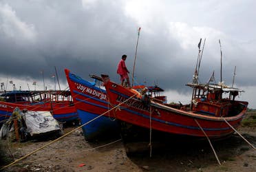 A fisherman ties his boat on a shore ahead of Cyclone Yaas in Digha in Purba Medinipur district in the eastern state of West Bengal, India, on May 25, 2021. (Reuters)