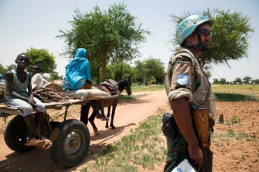 A handout picture released by the United Nations-African Union Mission in Darfur (UNAMID) on July 27, 2012 shows a UNAMID peacekeeper from Ethiopia getting inside an armoured personnel carrier (APC) before going on a night patrol in Gereida, South Darfur, on July 25, 2012. The UNAMID has deployed a battalion of 800 soldiers from Ethiopia to protect civilians in Gereida, months after clashes between Sudanese government troops and the rebel Sudan Liberation Army (SLA). (AFP)