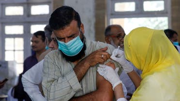A man receives a dose of a coronavirus disease (COVID-19) vaccine, at a vaccination center in Karachi, Pakistan. (Reuters)
